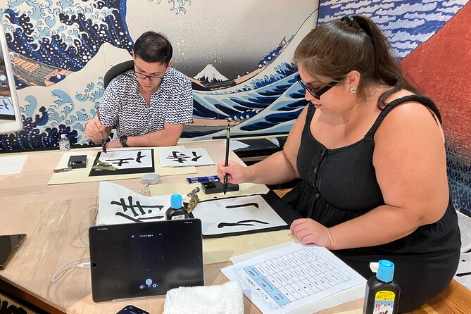 Calligraphy Workshop at Traditional Folk Craft Shop in Hiroshima - A calm setting with ukiyo-e on the wall