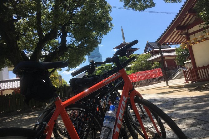 Eat, Drink & Cycle: Osaka Foodie Bike Tour - Meeting beneath Tsutenkaku and getting fitted for a bike