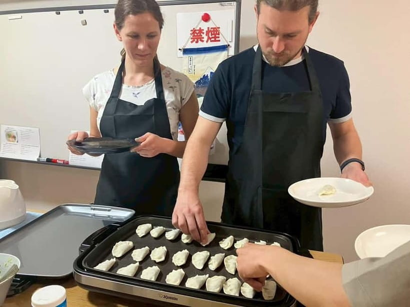 Osaka: Cooking Class Ramen & Gyoza Course in Nanba - Folding gyoza with the group