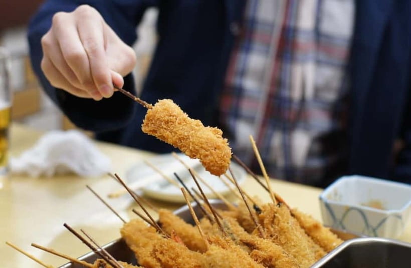 Osaka: Food Tour Kuromon Market & Dotonbori with Guide - Kuromon Market: takoyaki and three-colour dango