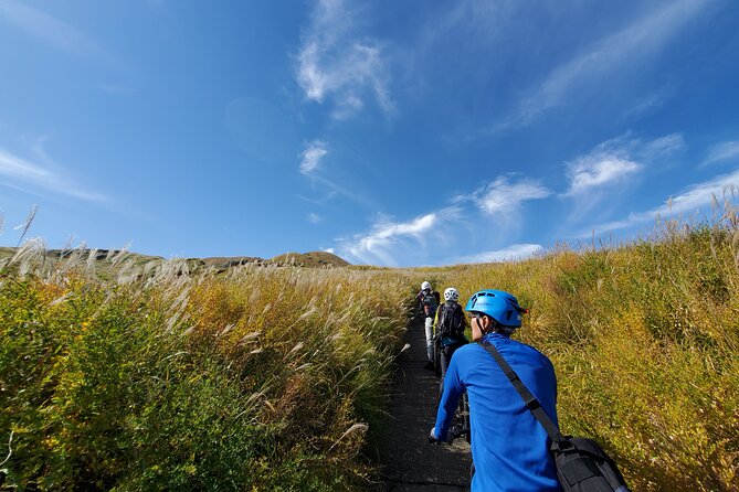 Private E-MTB guided cycling around Mt. Aso volcano & grasslands - The downhill return and the widening caldera view